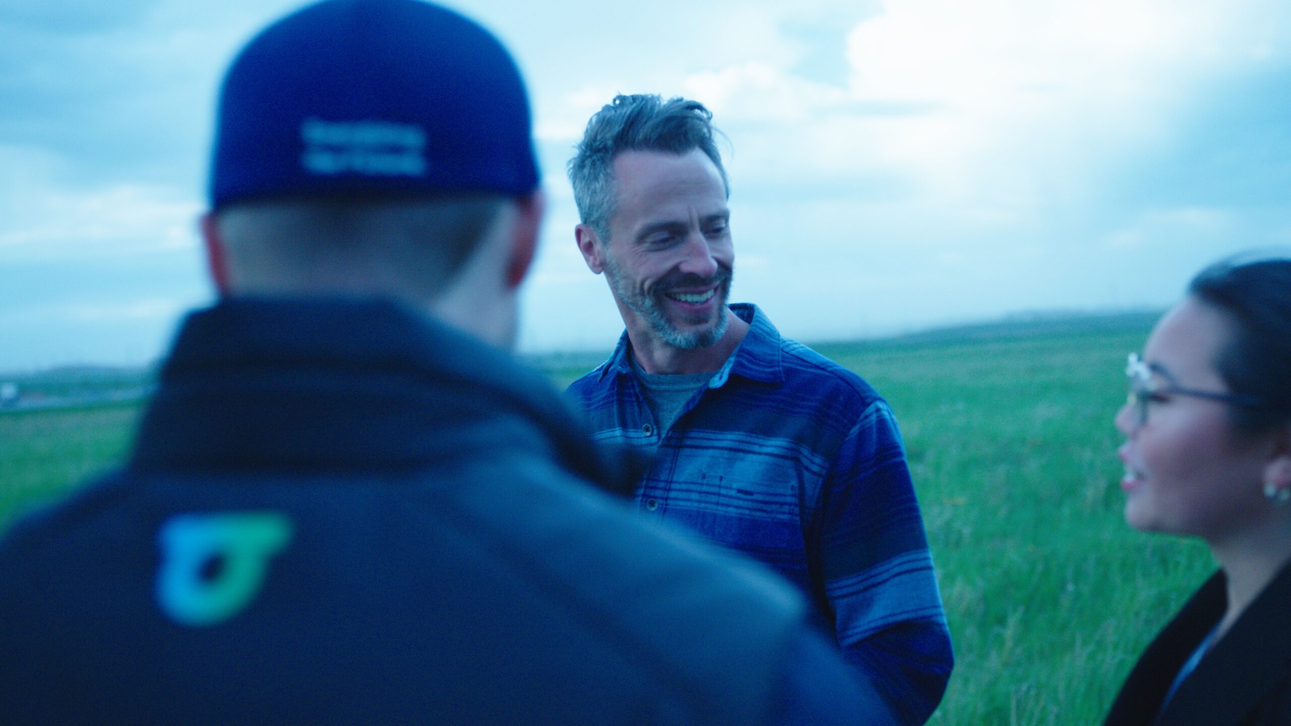 community engagement at a project site between two male and one female employees
